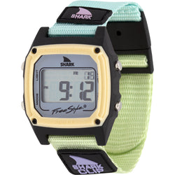 A Freestyle SHARK CLASSIC CLIP GREEN TEA digital watch with a green and black Shark Clip band and rectangular digital display.
