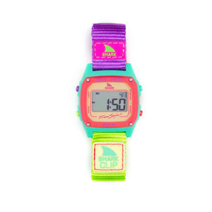 Freestyle SHARK CLASSIC CLIP SOUR APPLE watch with purple/yellow strap, turquoise/pink case, digital display on the screen.