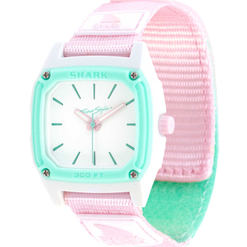 The Freestyle SHARK CLASSIC LEASH ANALOG SEAFOAM is a pastel pink and mint watch featuring a square face and pink strap.