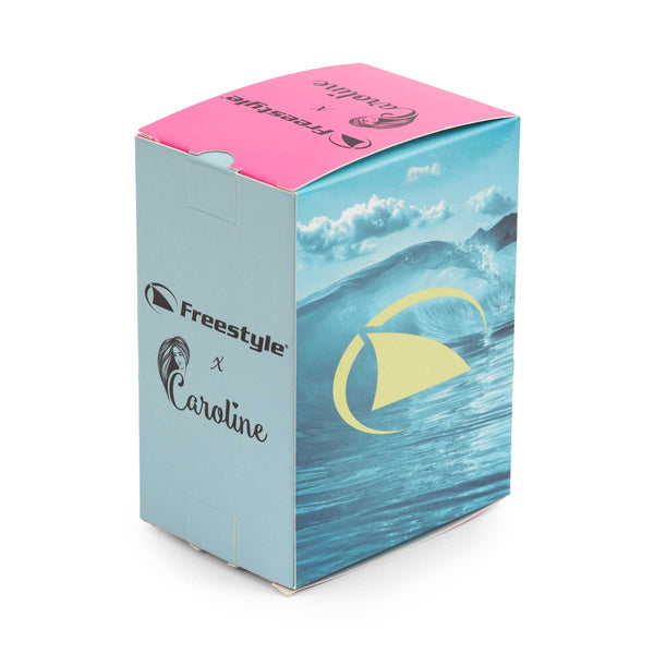 A vibrant product box adorned with ocean waves and a wave logo, ideal for surf enthusiasts. In clear blue sky hues, it reads Freestyle x Caroline, featuring a pink top and teal sides, showcasing the CAROLINE MARKS SIGNATURE SHARK CLASSIC LEASH.