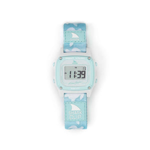 Freestyle SHARK CLASSIC CLIP TRIPPY TURTLE AQUA watch with blue/white strap, digital numbers visible on the face.