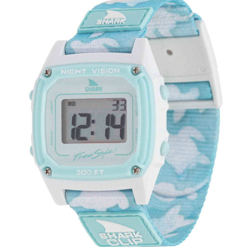 A Freestyle SHARK CLASSIC CLIP TRIPPY TURTLE AQUA digital watch with a blue & white band displays numbers on its screen and features the Shark logo.