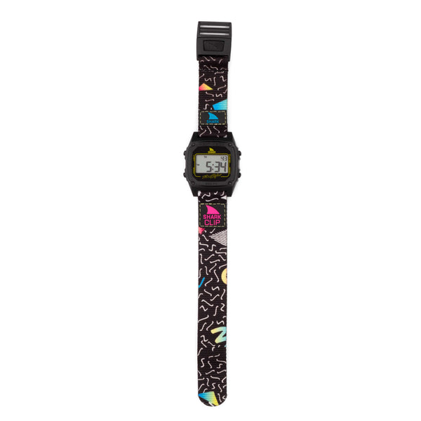 The Freestyle SHARK CLASSIC CLIP NEW WAVE is a digital watch with a black case and retro-futuristic patterned strap.