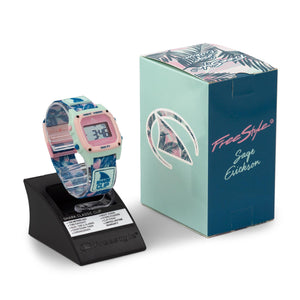 Freestyle SAGE ERICKSON SIGNATURE SHARK CLASSIC CLIP BLUE SAGE PALM watch on a stand beside its matching box.
