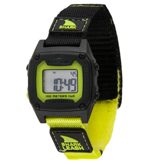 Freestyle digital watch with a black and yellow Shark Leash strap; display shows 4:49, Shark Mini branding visible.