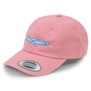 Angled view of the Freestyle Dad Cap Signature Cotton Unstructured in pink, showing the pastel pink cotton fabric with a light blue embroidered Freestyle logo on the front and a curved brim with adjustable fit.