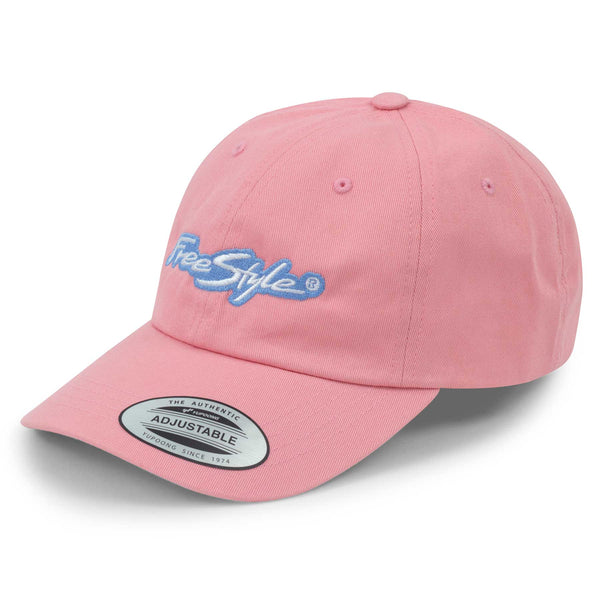 Angled view of the Freestyle Dad Cap Signature Cotton Unstructured in pink, showing the pastel pink cotton fabric with a light blue embroidered Freestyle logo on the front and a curved brim with adjustable fit.