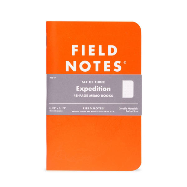 An orange Freestyle USA EXPEDITION WATERPROOF NOTEBOOK with a gray band, tearproof paper, and product information.